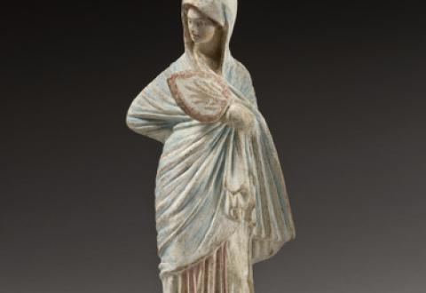 Female figurine with a fan